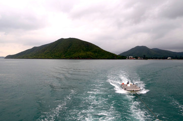 Motor boat in tow. Thailand.