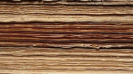 Fototapeta premium Pages of old, vintage, antiquarian books pile, сlose-up front view, texture