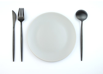 Empty plate and modern cutlery isolated on white background. Stylish setting.
