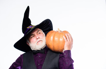 Senior man white beard celebrate Halloween with pumpkin. Magic concept. Experienced and wise....