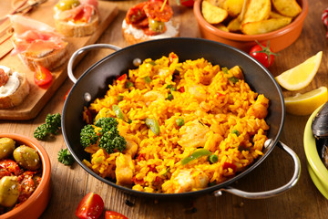 cooking pan with paella with seafood