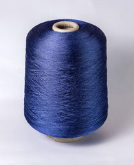 bobbin of yarn on a white background. Side view.Textile reel on isolated white background.