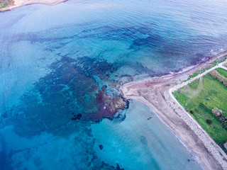Wonderful aerial view at sunset of the coastline of Portopalo, a town in the southern Sicily. The shot is taken during a beautiful sunny day at sunset