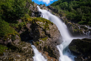 Naklejka na ściany i meble Kleivafossen Waterfall in the Jostedalsbreen National Park, Sogn og Fjordane, Norway. Long exposure shot. July 2019