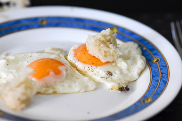 Closeup of fried eggs served at the plate / Healthy breakfast concept
