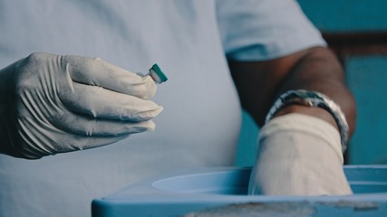 Melsisi, Pentecost Island / Vanuatu - May 10 2019: female woman local village medical nurse doctor working vaccination arrived in a carrier box at the rural hospital clinic