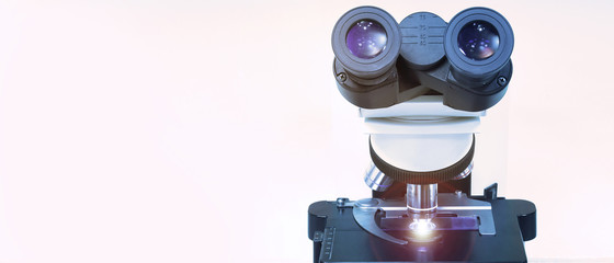 close up shot of microscope at the blood laboratory take with art lighting and blue filter