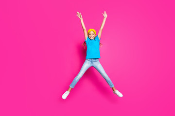 Full size photo of cute positive cheerful dreamy child jump raise her hands enjoy summer weekends...