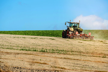 Fototapeta premium nice view of a farmer plowing his fields