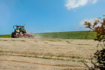 Fototapeta premium nice view of a farmer plowing his fields