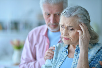 Close up portrait of sad senior couple posing