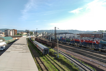 Fototapeta premium Railway station with freight and passenger trains in the city of Krasnoyarsk