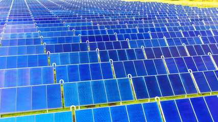 Ariel view , Shot from a drone on a farm field there are a lot of solar panels that produce...