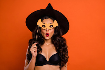Trick or treat halloween concept photo of beautiful nude brunette charming lady holding bat shaped...