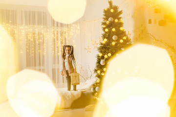 Merry Christmas and Happy Holidays. little girl in the room decorated for christmas