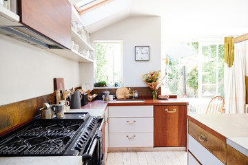 Empty Interior Of Contemporary Kitchen With Cooker And Storage