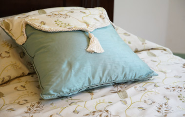Blue cushion on the bed