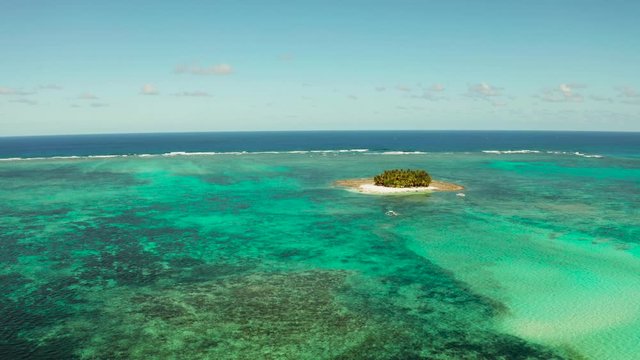 Guyam island, Siargao, Philippines. Small island with palm trees and a white sandy beach. Philippine Islands.