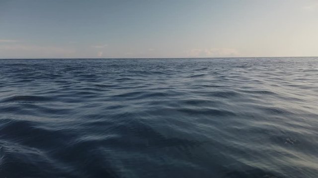View of calm ocean water surface with small waves and empty horizon