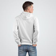 Design of a white hoodie mockup on a young man standing with his back.
