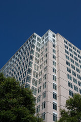 A modern Stone and Glass Tower in Blue Sky