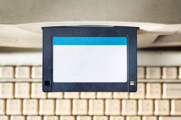 Close up of floppy disk insert into the drive A of the old computer