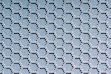 The closeup image of low relief hexagon texture of grey synthetic rubber