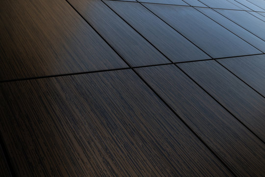 Diagonal view of dark brown venge tile wall surface, wood imitation texture