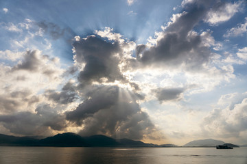 Naklejka na ściany i meble Sunlight through the clouds at dawn, island Koh Samui, Thailand