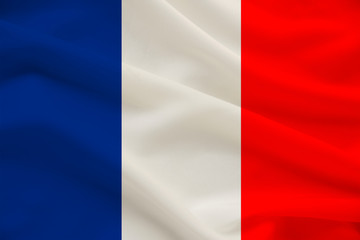 Obraz premium national flag of the country france on gentle silk with wind folds, travel concept, immigration, politics, copy space, close-up