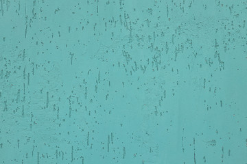 Elevated view of mint-colored unsmooth painted wall of building