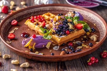 Belgian waffles with blueberry cream, granola and fresh berries, Tasty breakfast, Horizontal orientation