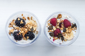 Chia pudding with yogurt, blackberries, raspberries, bananas and oatmeal served in cups