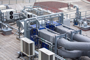 External infrastructure of the microclimate support system at a large industrial site. Air pipelines inlet and exhaust. Fans and air conditioning. Systems of control of pressure, humidity, temperature