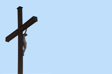 Christian crucifix on a wooden high cross, copy space, isolate