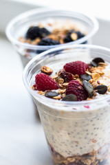 Chia pudding with yogurt, blackberries, raspberries, bananas and oatmeal served in cups