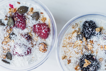 Chia pudding with yogurt, blackberries, raspberries, bananas and oatmeal served in cups
