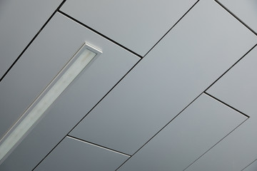 Ceiling covered with smooth white panels with a lamp