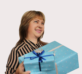 smiling woman holding a gift in blue paper with a ribbon on a light background, concept of Valentine's Day, Christmas presents, mother's day, new year, close-up, copy space
