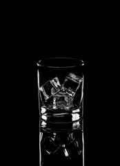 Vodka or gin tonic with ice in rocks glass on black background