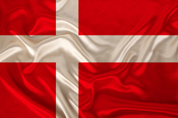 photo of the national flag of Denmark on a luxurious texture of satin, silk with waves, folds and highlights, close-up, copy space, concept of travel, economy and state policy, illustration