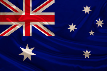 Fototapeta premium photograph of the national flag of Australia on a luxurious texture of satin, silk with waves, folds and highlights, closeup, copy space, travel concept, economy and state policy, illustration