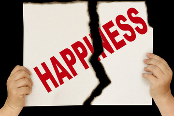 female hands are holding on a black background a sheet of cardboard torn in two with the word...