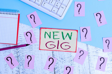 Text sign showing New Gig. Business photo text getting job Attending live Concert Gigabyte Freelancer offer Writing tools, computer stuff and math book sheet on top of wooden table