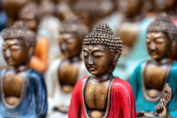 Buddha statue figures souvenir on display for sale on street market in Bali, Indonesia. Handicrafts and souvenir shop display, close up