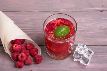 Glass of fresh strawberry smoothie and fresh strawberries on pink wooden background. Healthy food...