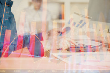 Double exposure of graph with man typing on computer in office on background. Concept of hard work. Closeup.