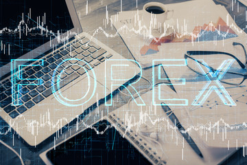 Double exposure of forex graph and work space with computer. Concept of international online trading.