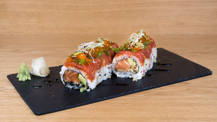 special roll of rice with salmon, avocado, different types of caviar