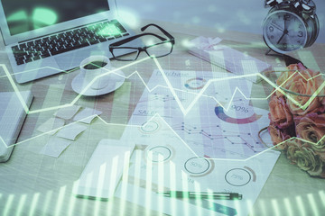 Stock market chart hologram drawn on personal computer background. Multi exposure. Concept of investment.
